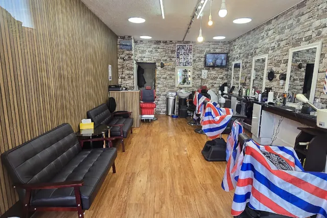 Inside Stockport Barber: the chairs, sofa and stone wall